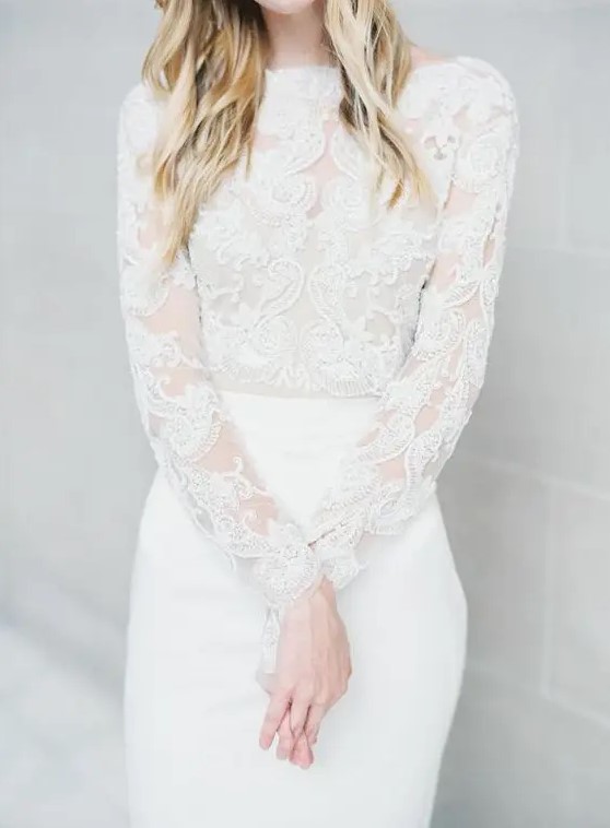 an ethereal wedding dress with a lace bodice with long sleeves, a high neckline and a sleek skirt
