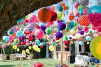 an outdoor boho wedding lounge styled and accented with colorful paper lanterns and just pompoms looks adorable
