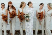 casual sleeveless off-white jumpsuits, statement earrings and mustard mules for a modern wedding