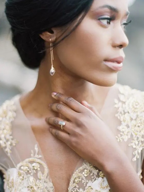 chic golden earrings with rhinestones match the ring and match the dress with gold embroidery
