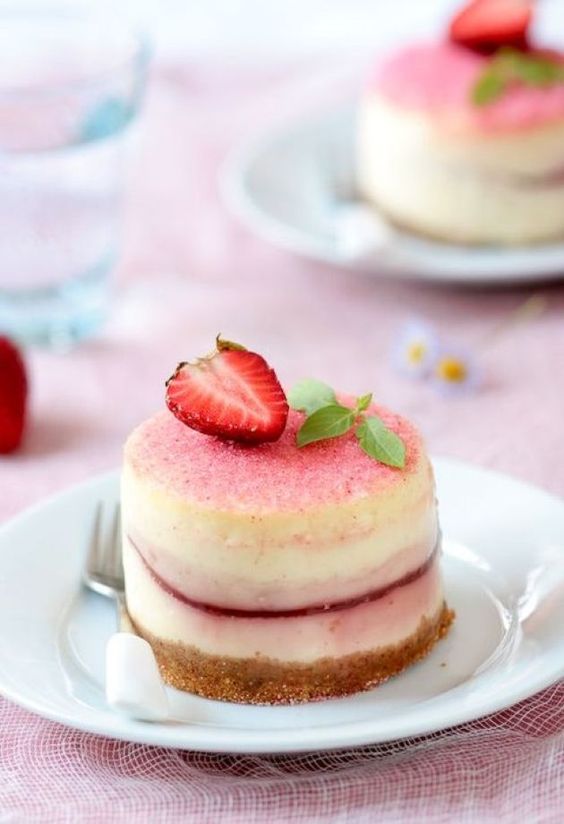 delicious mini peach cheesecakes with fresh strawberries and mint on top look cute and are tasty