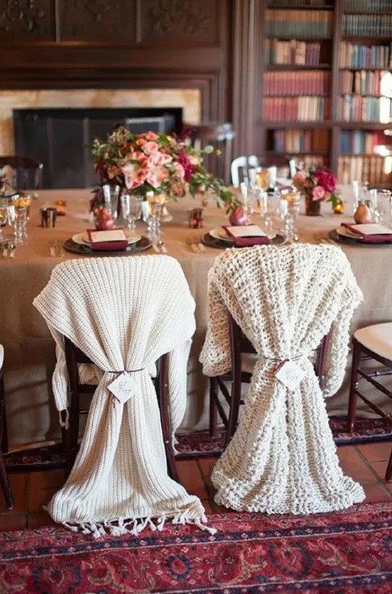 differently knit chair covers for the bride and groom instead of usual signs look very winter like