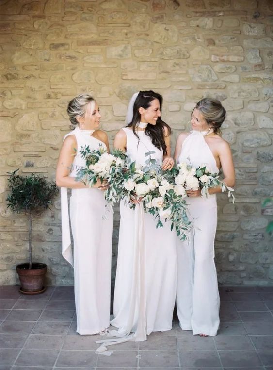 elegant and sophisticated white halter neckline jumpsuits with flare pants are a chic idea for a modern wedding