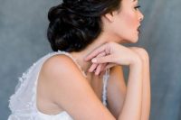 gold moon and star hair pins highlight this low updo giving it a romantic and fresh look