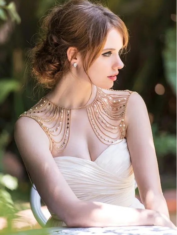gorgeous gold and beads and pearls shoulder jewelry that echoes with the bridal hair and adds a warm feel