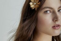loose waves with gold flower hair pins that add a refined and chic touch to the simple hairstyle