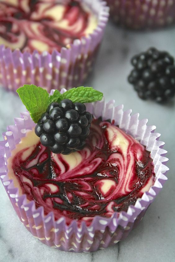 mini blackberry swirl cheesecakes topped with blackberries and mint are perfect for a fall wedding