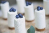 mini blueberry cheesecakes can be an addition to a larger cake on your dessert table