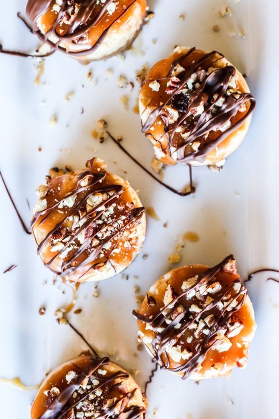 mini gluten free salted caramel cheesecakes with nuts and chocolate on top are amazing for fall