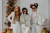 mismatching bridesmaid outfits with a white pantsuit and a gold sequin top, a floral pantsuit for a hippie wedding