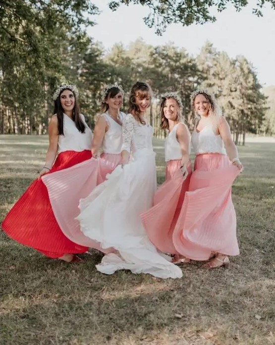 mismatching plain and lace tops and pink and coral plated maxi skirts plus neutral floral crowns and metallic sandals for a summer boho wedding