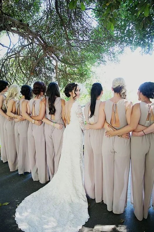 neutral fitting bridesmaid jumpsuits with high necklines and cutout backs with ties for a modern feel