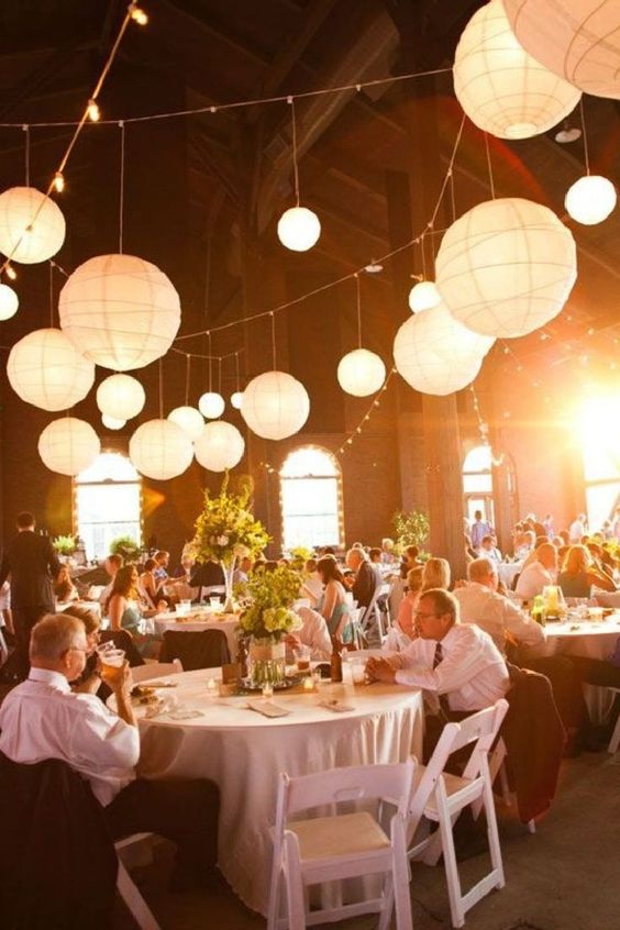 paper lanterns paired with string lights are a great idea for many wedding receptions, they give a slight and delicate glow to it