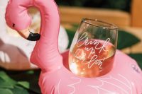 pink flamingo floats for holding drinks are a cool idea for a summer or tropical wedding or if you are hosting in a venue with a pool