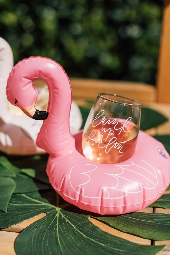 pink flamingo floats for holding drinks are a cool idea for a summer or tropical wedding or if you are hosting in a venue with a pool