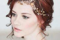 romantic yet bold red hair updo with a gold and white hair vine on the side