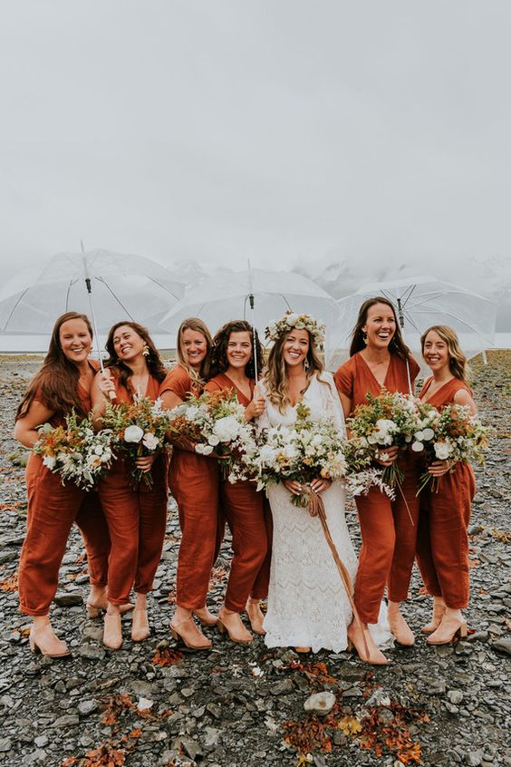 rust-colored bridesmaid jumpsuits, short sleeves, nude shoes are a cool idea for a fall boho wedding