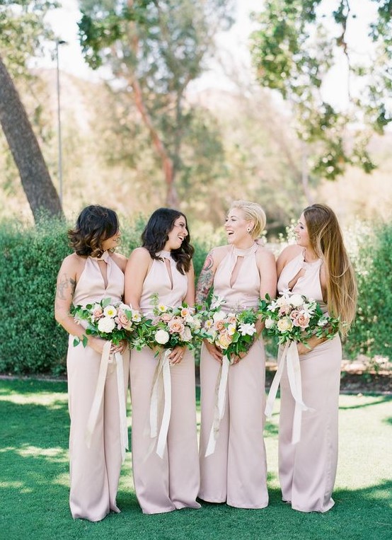 sexy blush jumpsuits with a halter cutout neckline and wide pants for a summer wedding