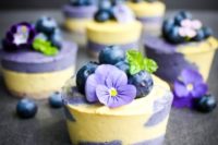 vegan mini cheesecakes topped with berries and flowers are a delicious dessert for a summer wedding