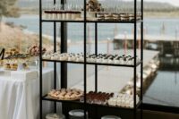 a black storage shelf as an additional piece for the wedding dessert table