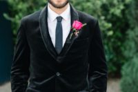 a black velvet blazer, a white shirt, a grey thin tie and grey pants for a simpler and non-formal groom’s look