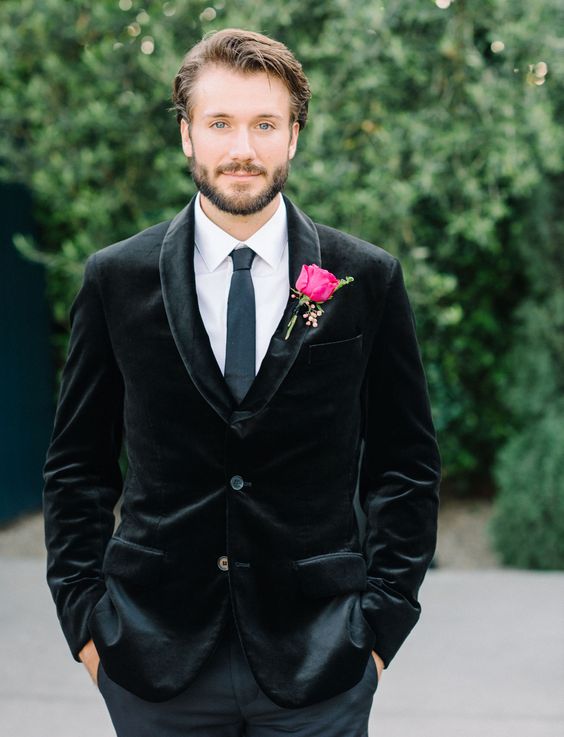 a black velvet blazer, a white shirt, a grey thin tie and grey pants for a simpler and non-formal groom's look