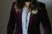 a boho groom’s look with a purple floral print blazer, white jeans, an off-white shirt and a hat for a fall wedding