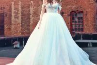 a breathtaking off the shoulder wedding ballgown with a lace bodice and straps, a train and a statement headpiece