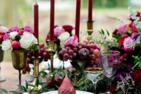a bright and lush fall wedding tablescape with bright blooms, marsala candles, berries and fruits, pears as cards is amazing