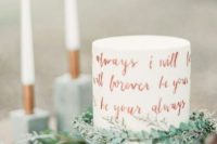 a buttercream wedding cake with vows or quotes donne with copper leaf is a stylish and bold modern idea