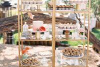 a couple of tall brass shelves decorated with coral and peachy blooms and with lots of delicious sweets on display will let you save some space