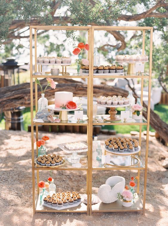 a couple of tall brass shelves decorated with coral and peachy blooms and with lots of delicious sweets on display will let you save some space