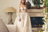 a fantastic princess-inspired off the shoulder wedding dress with a corset bodice, lace applique and a layered skirt and puff sleeves