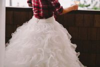 a flannel shirt as a coverup is a great idea for a rustic bride and it looks cool with your wedding gown