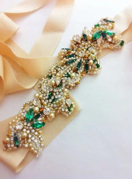 a gorgeous embellished bridal sash with pearls, rhinestones and emeralds looks wow and will add a touch of shine to your look