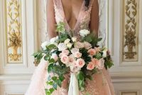 a gorgeous pink princess style wedding dress with a plunging neckline, beading and white floral lace appliques
