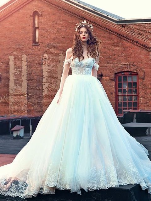 a gorgeous princess wedding ballgown with a lace bodice, off the shoulder neckline and a full skirt with a lace edge
