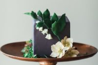 a grey square buttercream wedding cake decorated with sugar blooms and leaves is a catchy and unusual idea