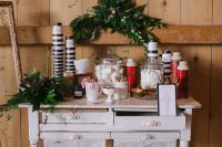 a hot cocoa bar done with greenery, plaid thermoses and delicious sweets is amazing for a Christmas wedding