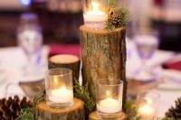 a natural wedding centerpiece of moss and evergreens, tree stumps, pinecones and floating candles