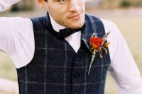 a navy plaid waistcoat, a white shirt and a black bow tie plus a red flower boutonniere are very chic