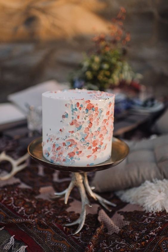 a one tier white wedding cake decorated with pastel colored dabs is a beautiful idea for spring