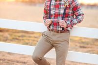 a plaid red shirt, navy suspenders, tan pants, brown shoes and a green bow tie for a relaxed rustic look
