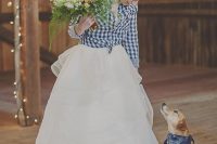 a plaid shirt over the wedding dress is a stylish coverup idea to rock, perfect for a rustic wedding