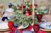 a plaid wedding table runner will add coziness to your tablescape and here it contrasts the blues and greenery