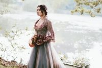 a purple grey A-line wedding dress with a floral embroidery bodice and long sleeves, a deep neckline and a train