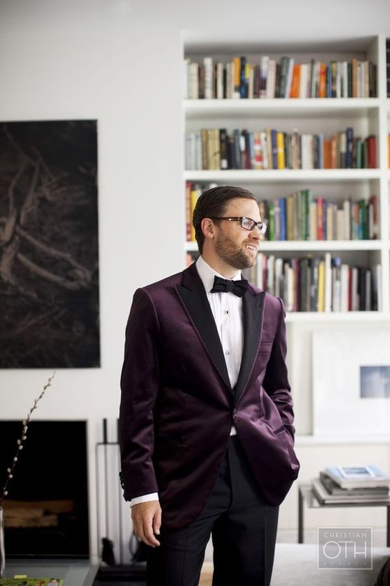 a refined groom's look with a purple velvet blazer with black lapels, a black bow tie and black pants