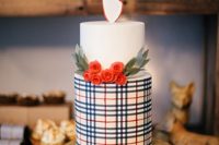 a reindeer-topped cake features a festive plaid pattern set off with red wafer-paper rosebuds