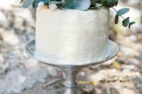 a textural buttercream one tier wedding cake with greenery and fresh blooms on top for a romantic wedding