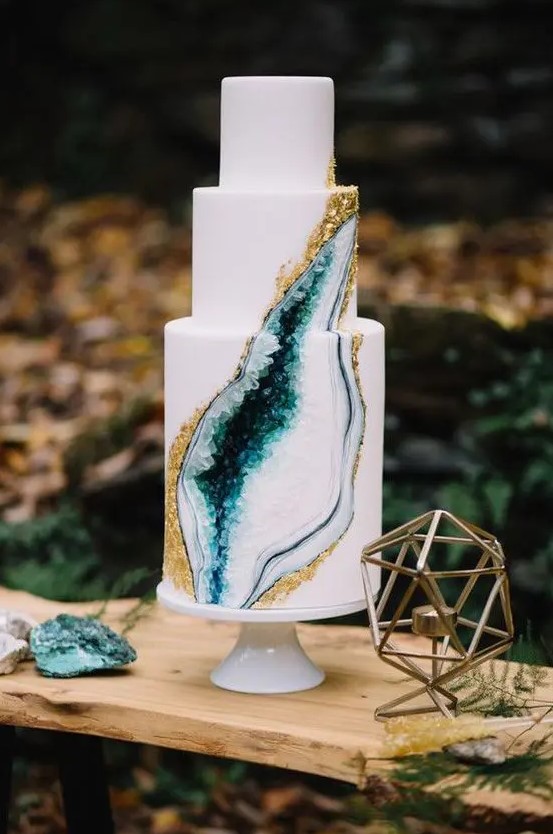 a trendy wedding cake with a gold edge and emerald geode crystals inside is a fantastic idea for a fall wedding